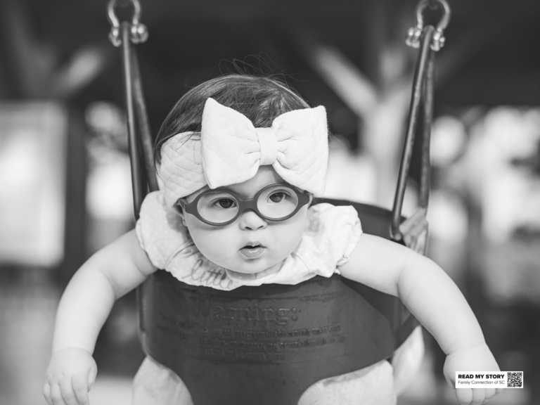 young girl sits in a swing