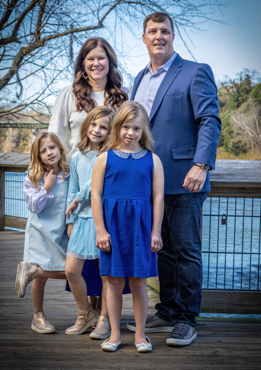 Felder Family mother father and three daughters stand by the river.